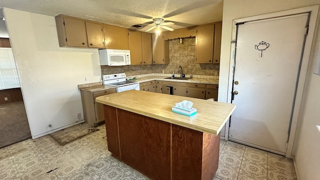 kitchen with backsplash, white appliances, a textured ceiling, a ceiling fan, and a sink