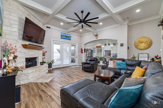 4710 Shadow Crk, San Angelo, TX 76904 - living area with a ceiling fan, wood finished floors, a stone fireplace, beamed ceiling, and coffered ceiling