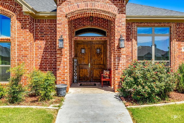 4710 Shadow Crk, San Angelo, TX 76904 - view of exterior entry featuring brick siding and a shingled roof