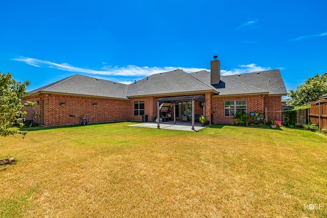 4710 Shadow Crk, San Angelo, TX 76904 - back of property with a patio area, a chimney, brick siding, and roof with shingles