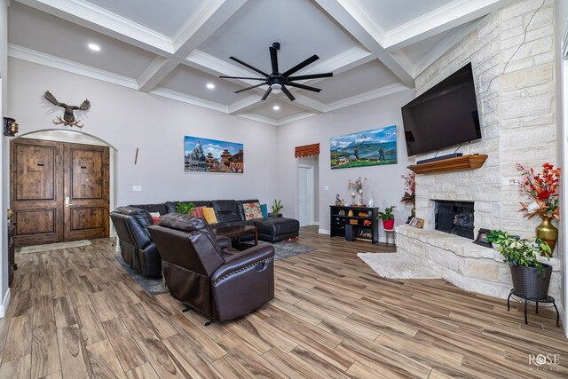 4710 Shadow Crk, San Angelo, TX 76904 - living room with beam ceiling, a ceiling fan, wood finished floors, a stone fireplace, and coffered ceiling