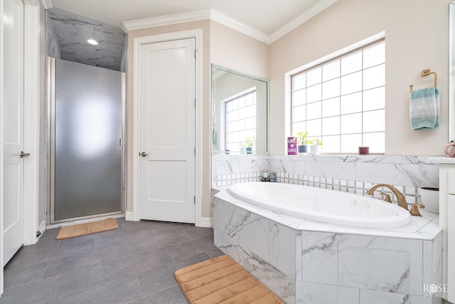 4710 Shadow Crk, San Angelo, TX 76904 - full bathroom with a shower stall, a garden tub, crown molding, tile patterned floors, and baseboards