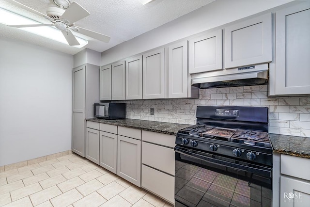 kitchen featuring dark stone counters, gray cabinets, and black appliances