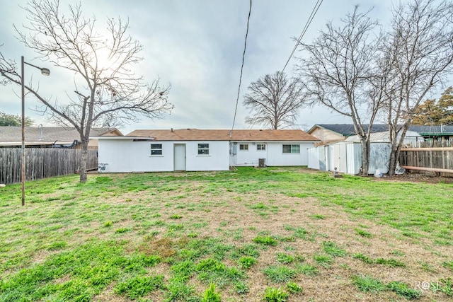 rear view of property featuring a yard