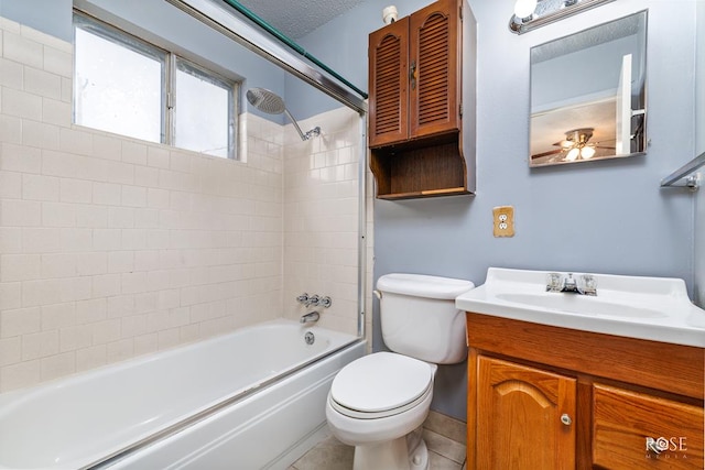 full bathroom featuring tiled shower / bath combo, vanity, tile patterned flooring, toilet, and a textured ceiling