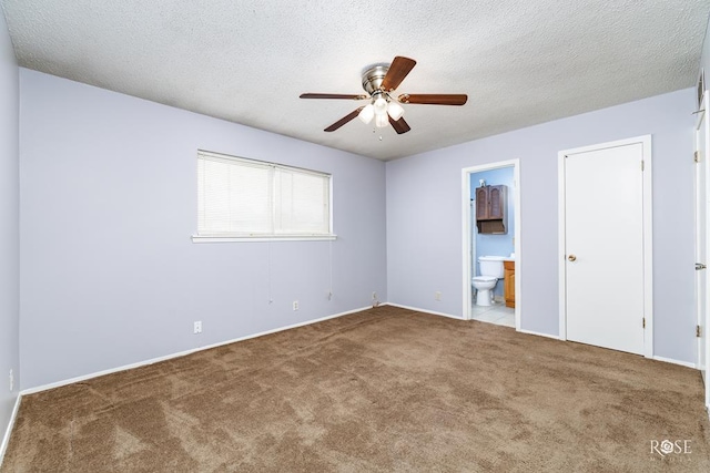 empty room featuring ceiling fan, a textured ceiling, and carpet flooring