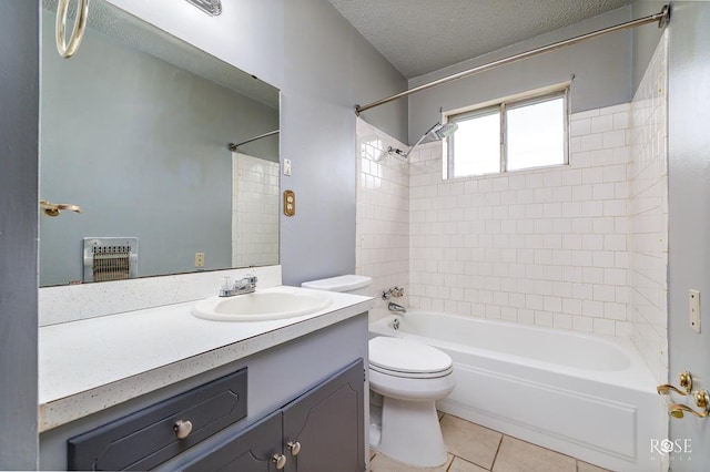 full bathroom with tile patterned floors, toilet, tiled shower / bath, a textured ceiling, and vanity