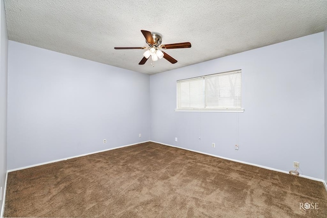 carpeted empty room featuring ceiling fan and a textured ceiling