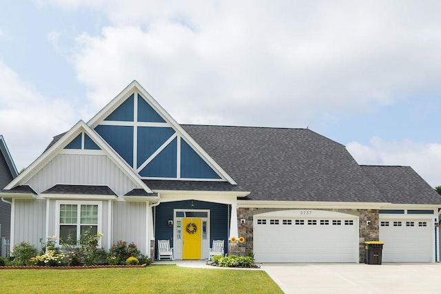 view of front of house featuring a garage, covered porch, and a front lawn