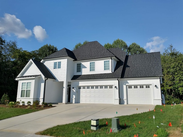 view of front of property with a garage and a front lawn