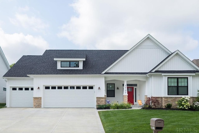 view of front of property featuring a garage and a front yard