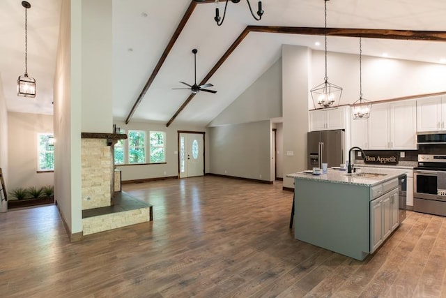 kitchen with light hardwood / wood-style flooring, beam ceiling, white cabinetry, and high vaulted ceiling