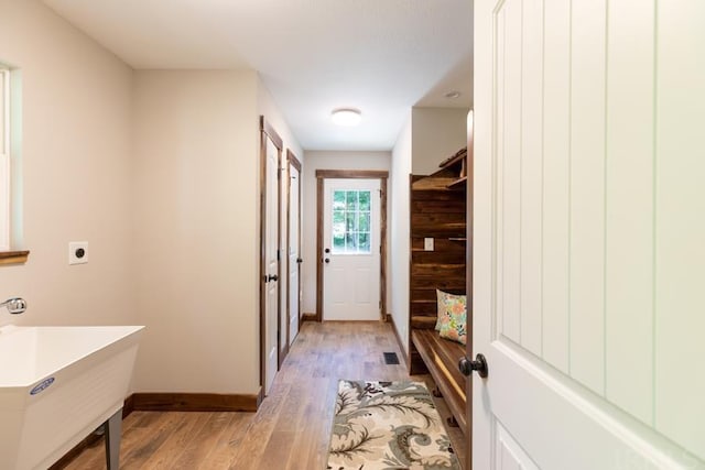 hall featuring light hardwood / wood-style floors and sink