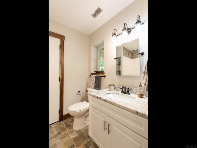 bathroom featuring toilet, large vanity, and tile floors