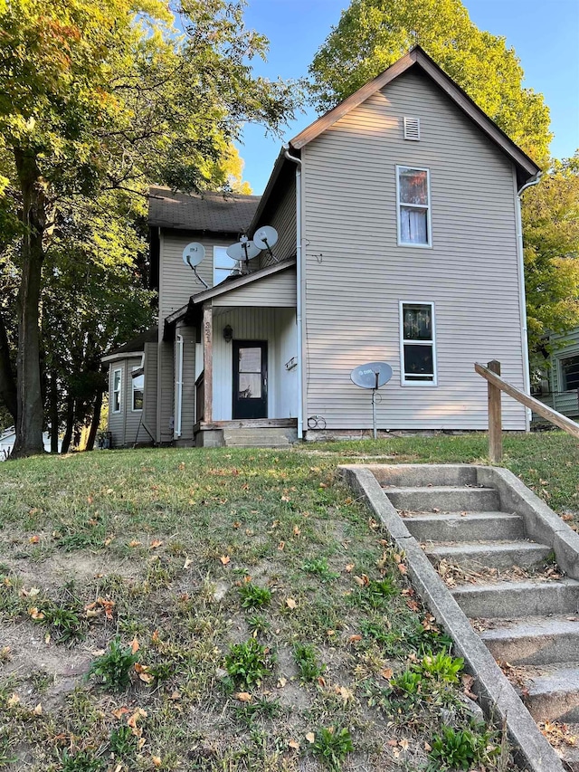 back of house featuring a yard