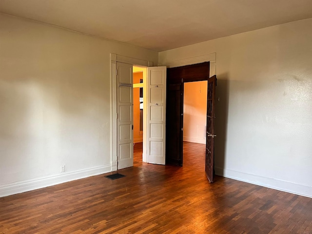 spare room with dark hardwood / wood-style flooring