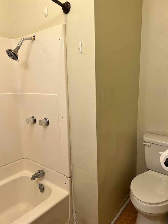 bathroom with shower / washtub combination and toilet