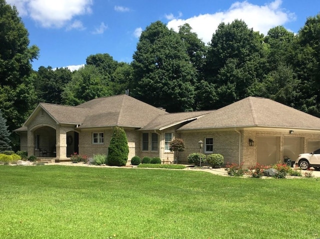 ranch-style house featuring a front lawn and a garage