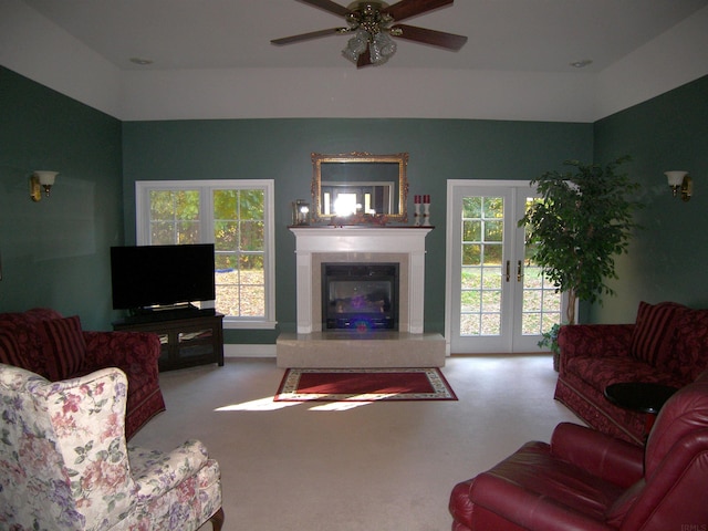 carpeted living room with french doors and ceiling fan