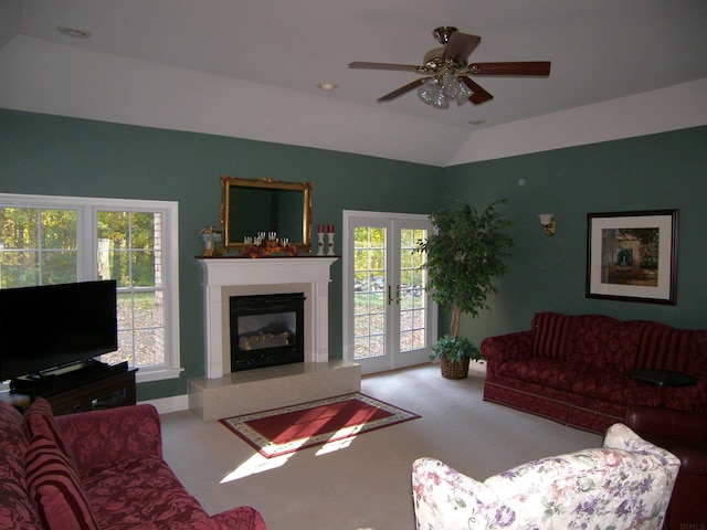 living room featuring french doors, vaulted ceiling, ceiling fan, and carpet