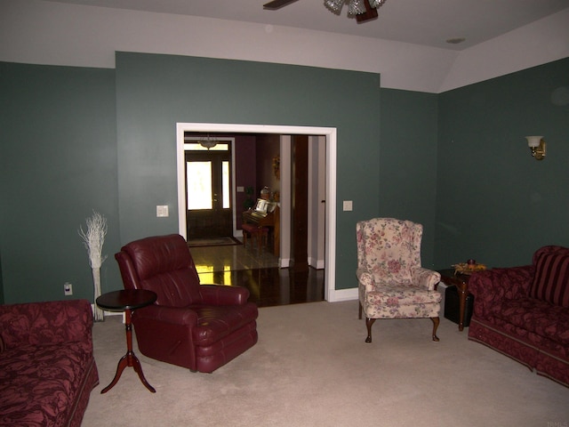 living room featuring lofted ceiling, carpet flooring, and ceiling fan