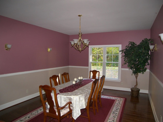 dining area featuring a notable chandelier and dark hardwood / wood-style flooring