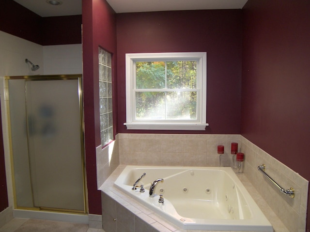 bathroom featuring separate shower and tub