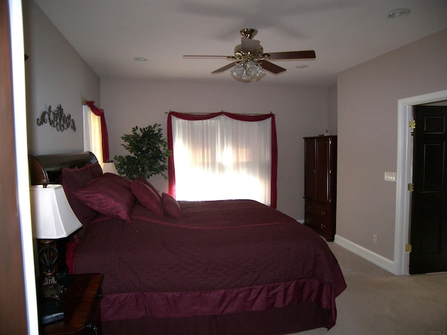 bedroom with ceiling fan and light carpet