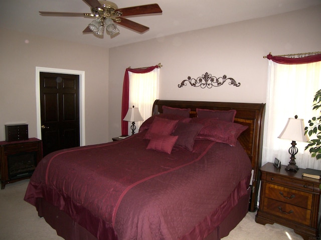 bedroom with light colored carpet and ceiling fan