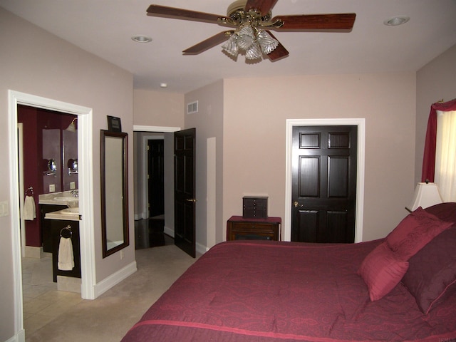 bedroom with ceiling fan, ensuite bathroom, and light tile flooring