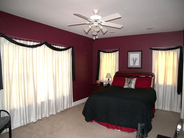 bedroom with ceiling fan and light colored carpet