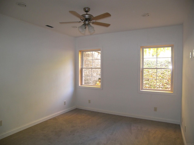 carpeted empty room featuring ceiling fan