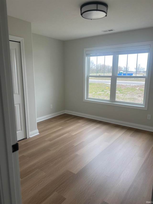 empty room with hardwood / wood-style floors