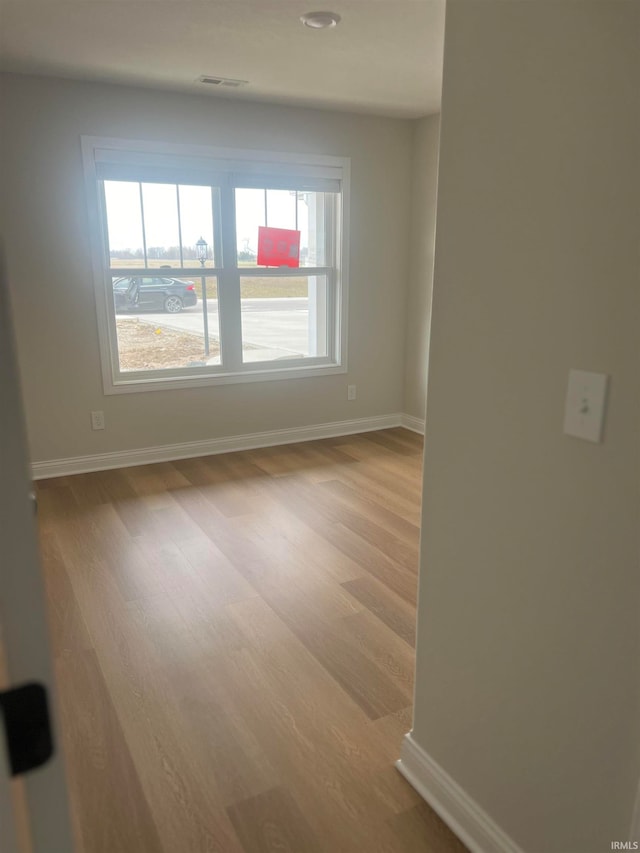 unfurnished room with wood-type flooring