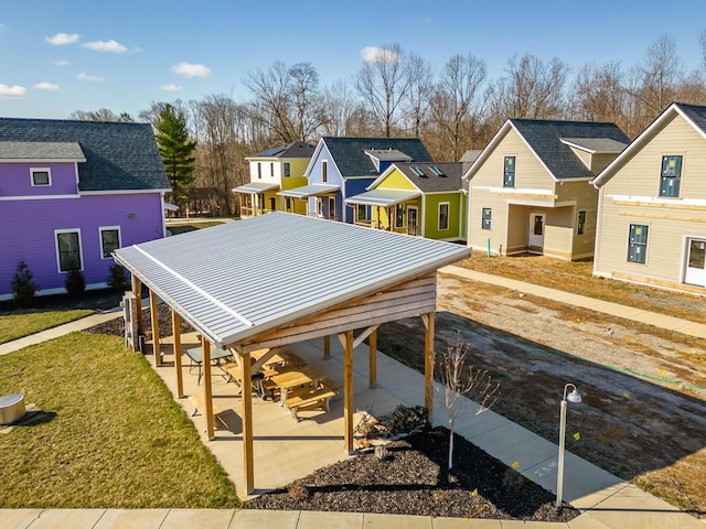 exterior space featuring a carport and a front lawn