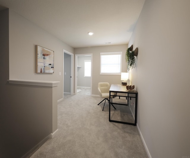 office with carpet floors, visible vents, and baseboards