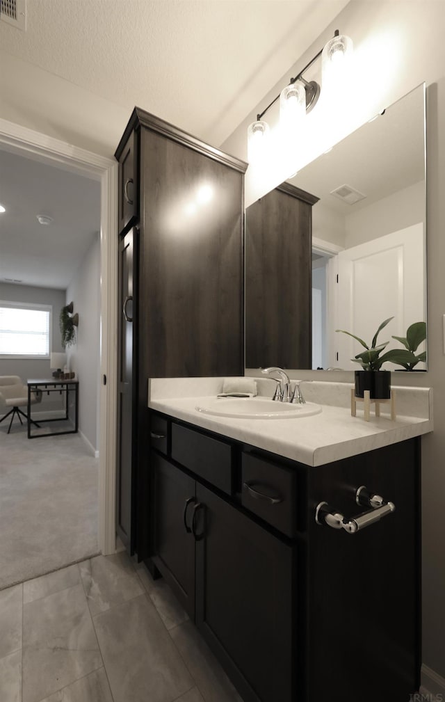 bathroom featuring vanity and visible vents