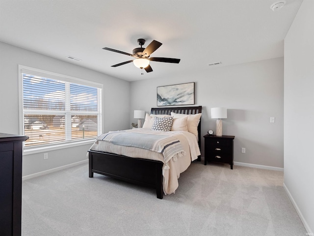 bedroom featuring ceiling fan, visible vents, baseboards, and light colored carpet