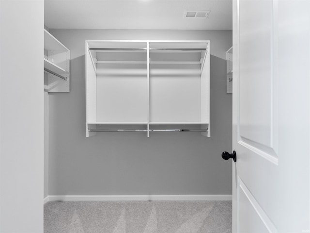 spacious closet featuring carpet flooring and visible vents