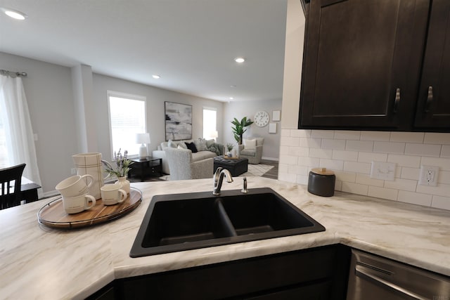 kitchen featuring recessed lighting, a sink, dark brown cabinets, decorative backsplash, and dishwasher