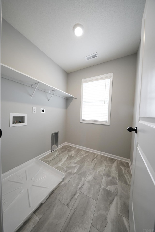 laundry area with hookup for a washing machine, hookup for an electric dryer, laundry area, visible vents, and baseboards