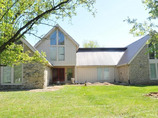 rear view of house featuring a lawn