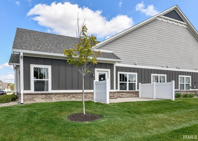 back of house with a lawn