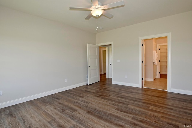unfurnished bedroom featuring ceiling fan and dark wood-type flooring
