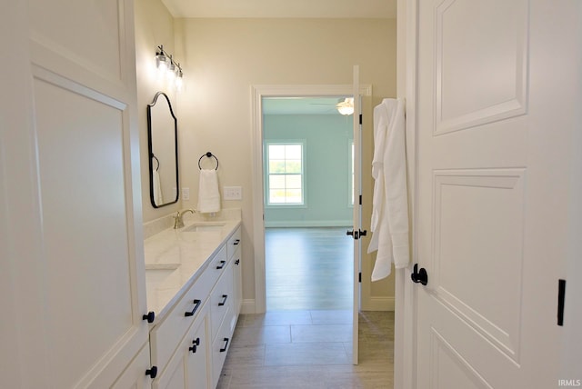 bathroom featuring dual sinks, hardwood / wood-style floors, ceiling fan, and oversized vanity