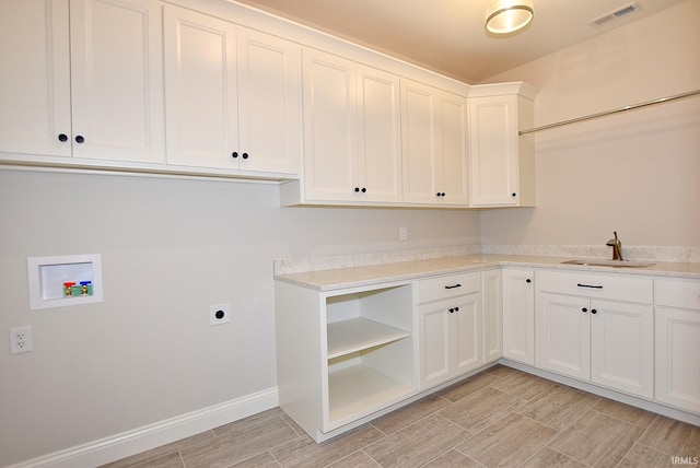 laundry area with sink, cabinets, electric dryer hookup, and washer hookup