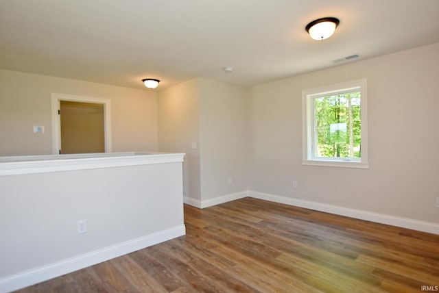 spare room with dark hardwood / wood-style flooring