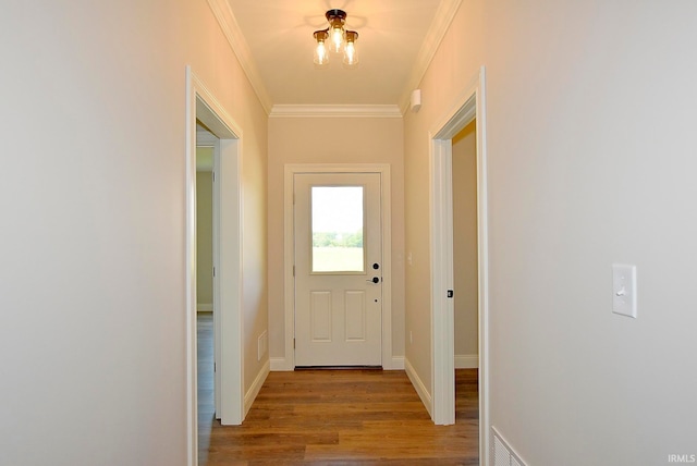 doorway featuring ornamental molding and dark hardwood / wood-style floors