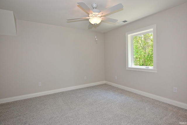 spare room featuring light colored carpet and ceiling fan