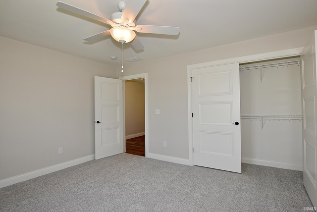 unfurnished bedroom featuring a closet, dark carpet, and ceiling fan